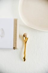 Ayuna Cream II on gold spoon